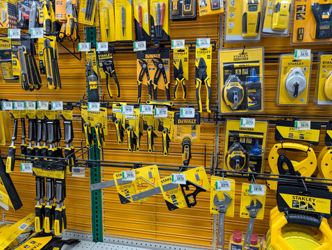 Quebec, Canada, 22 April 2026 : Various Stanley and DeWalt hand tools are displayed for sale on shelves in a retail store.