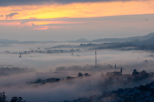 The view of Da Lat from Du Sinh Cemetery towards the city center. Da Lat on a morning shrouded in mist and early sunlight, a magical morning light. Beautiful Vietnamese scenery.