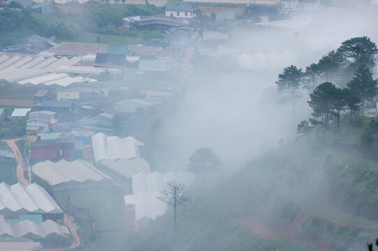 The view of Da Lat from Du Sinh Cemetery towards the city center. Da Lat on a morning shrouded in mist and early sunlight, a magical morning light. Beautiful Vietnamese scenery.