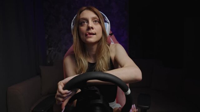 Playful Competitive Sim White Woman Teasing Rival With Cheeky Expression, Headset And Steering Wheel In Pink