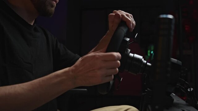 Tight Shot White Man Gripping Wheel, Studio Lighting With Microphone Visible, Fast Hand Movements In Simulated