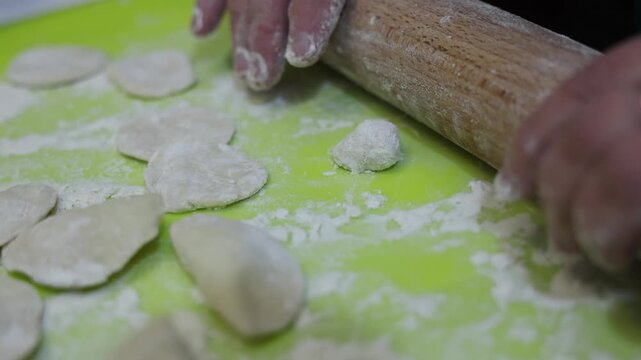 Close up of hands making traditional homemade dumplings with cottage cheese