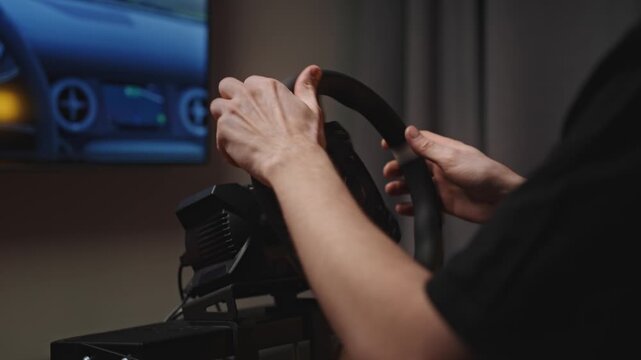 Hands swapping steering wheel and upgrading hardware on sim cockpit, removing quick release and fitting new wheel, focused setup