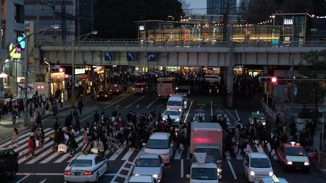 Pedestrians Crossing at Ueno JR Station Intersection in Tokyo, Japan at Dusk