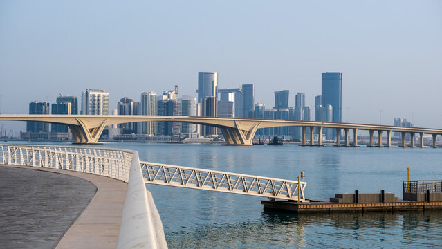 Abu Dhabi coastal city skyline with waterfront, bridge and modern buildings