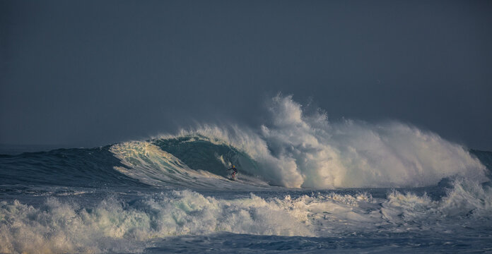 Surfer riding wave. Ocean scenery with copyspace. Huge waves crashing in ocean. Seascape environment background. Water texture with foam and splashes. Hawaiian surfing at Northshore in Oahy island

