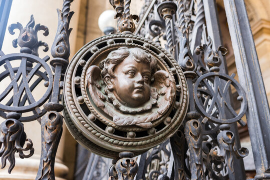 City gate features cherubic ironwork