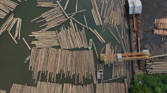 Aerial view of a sawmill sorting and processing wooden logs in water
