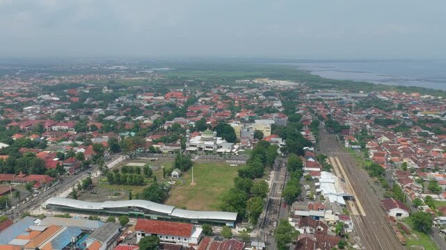 Drone flying above probolinggo city towards the java sea