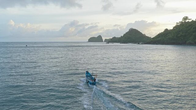 Traditional indonesian fishing boat sailing near red island java