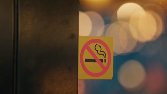 No smoke sign. No smoking sticker at entryway with cinematic reflective design. Warning decal at entrance highlighting no smoking alongside cinematic visual effects and urban lighting