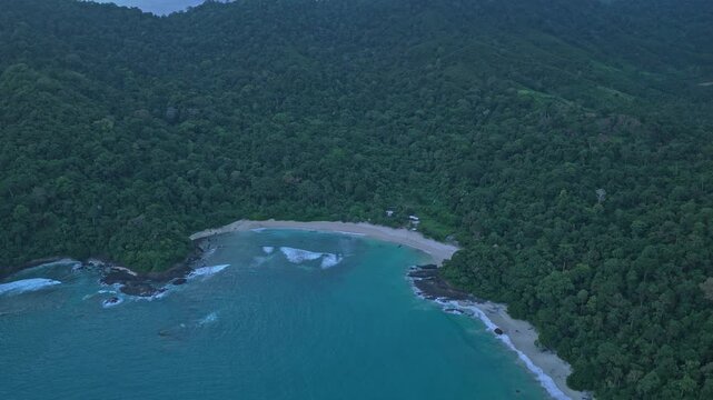 Aerial drone flying over red island tropical jungle beach in java