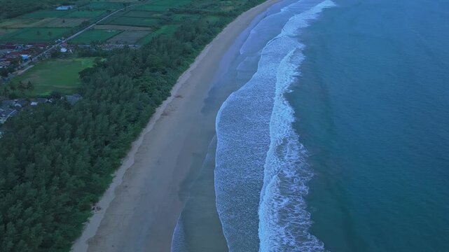 Aerial view of red island java coastline with breaking waves