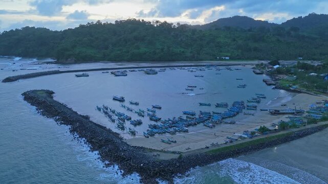 Aerial view of fishing boats docked in red island java harbor