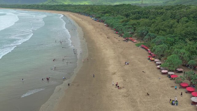 Aerial view of tourists enjoying an indonesian tropical beach