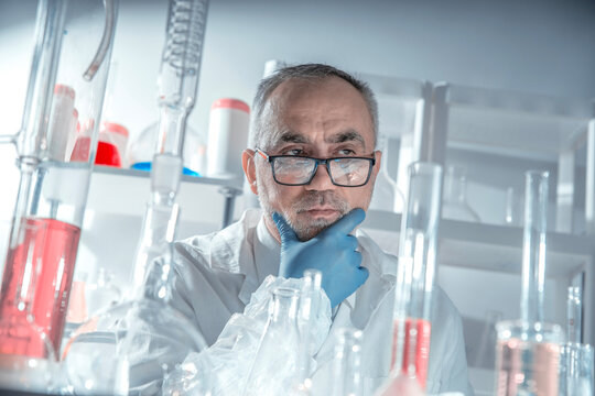 Scientist, laboratory, scientific portrait of a senior expert in glasses and gloves, calm and confident, evaluating results in chemical analysis and quality control.