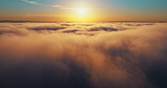 Sunset sun shining over clouds aerial. Dreamy heaven landscape golden hour sunlight blue sky. Drone shot high altitude flight summer travel exploration freedom concept scenic background.
