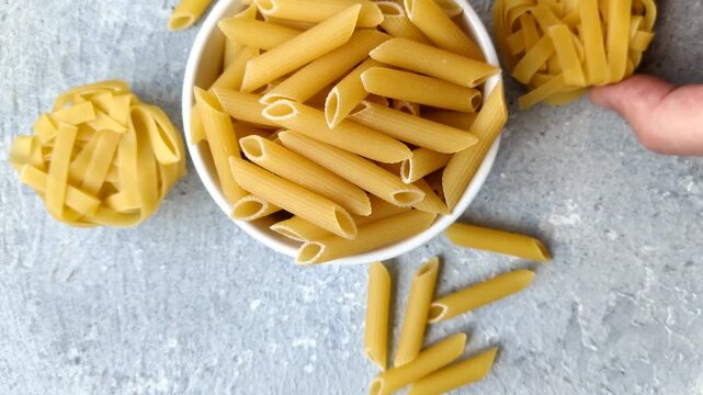 Italian uncooked dry penne regatta pasta with a gluten prohibition sign. The gluten prohibition sign as a background for your design.