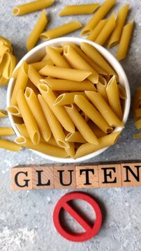 Italian uncooked, dry, gluten free penne regate pasta, ready for cooking. Dry, gluten free penne pasta as a food background for your design
