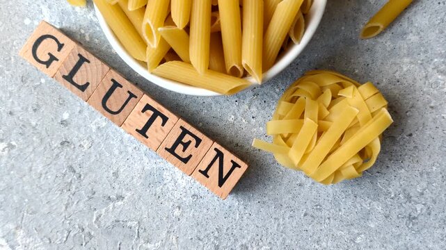 Italian uncooked dry penne regatta pasta with a gluten prohibition sign. The gluten prohibition sign as a background for your design.