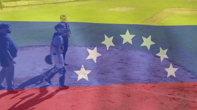 Baseball batter swinging on pitch, catcher rising for out, infield shifting under Venezuela flag