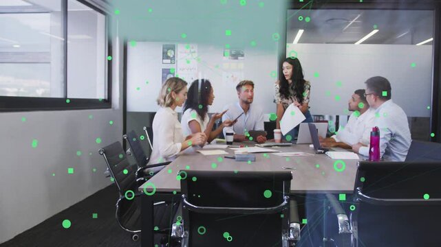 Presenter showing page, leading doc review in business, team using laptops, green dots overlaying