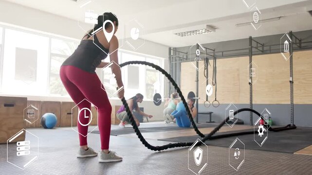 Woman entering frame gripping ropes and creating waves, hexagonal UI tracking waves for fitness