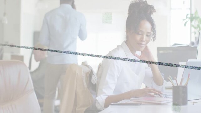 Woman studying screen, reacting, typing and filing in office, thin lines sweeping across screen