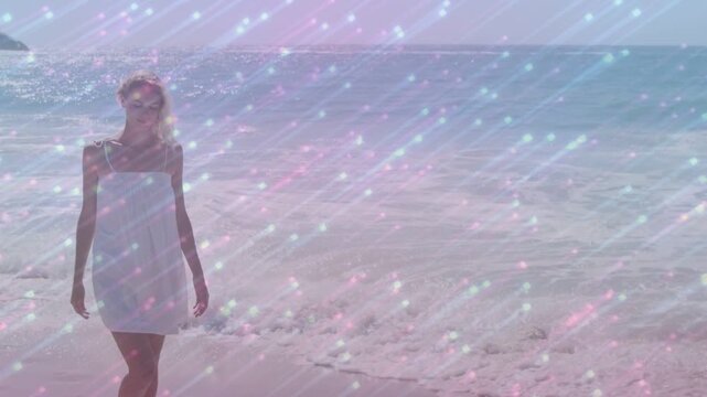 Woman walking shore toward camera, step starting tracking, overlay veiling face, fashion content