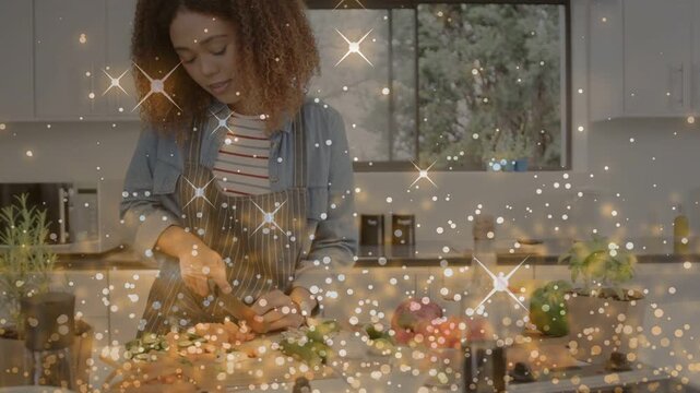 Woman starting meal prep chopping veggies on cutting board, sparkle overlay tracing knife motions