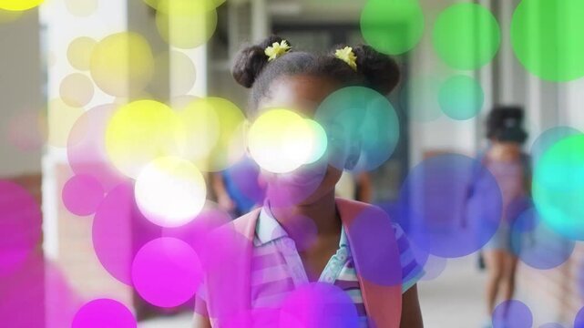Girl student walking toward cam in school pink pack cam-led color dots obscuring face showing focus
