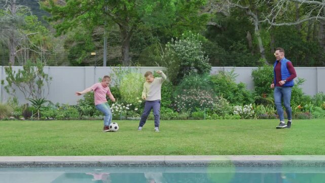 Center boy starting dribble left boy closing dad moving soccerball pool green flares adding for fun
