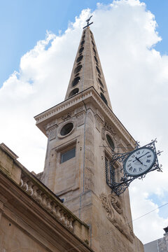 Historic church tower of &Eacute;glise Saint-Louis-en-l'&Icirc;le with ornate clock detail rising above Paris architecture