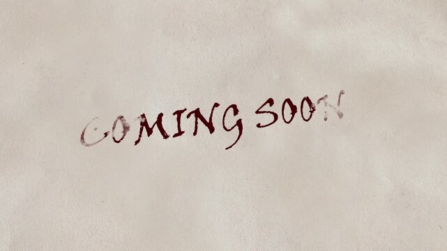 Red Ink Writing 'Coming Soon' on Textured Paper