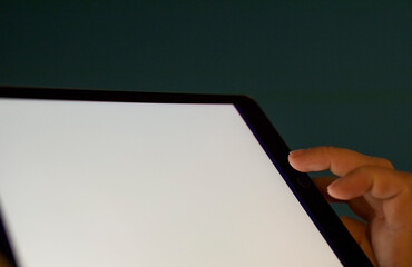 Close up of person's hand pressing on a tablet screen, perfect for tech or business visuals. © vegefox.com