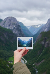 Naklejka premium Person, hands or travel with photo of mountain landscape, location or destination in nature. Traveler, adventure trip or picture with natural scenery for outdoor memory, capture moment or photography