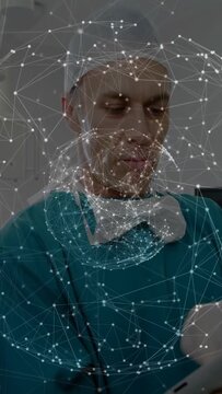 Vertical video: Doctor tapping tablet, reviewing patient data, showing AR node network over chest