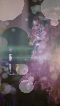 Vertical video: Vocalist leaning toward pop mic, singing into phones in studio with bokeh framing