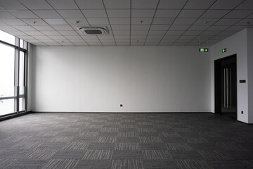 Empty modern office interior space with carpeted floor and ceiling grid lighting © zhu difeng
