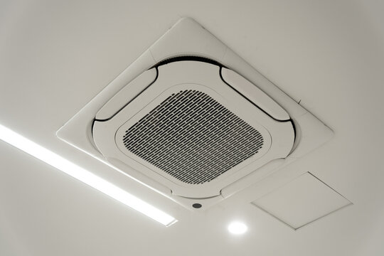 White square recessed ceiling-mounted air conditioning vent with metal grille and modern design