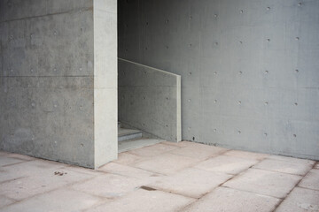 Naklejka premium Exposed concrete architectural staircase interior with geometric structure and textured surfaces