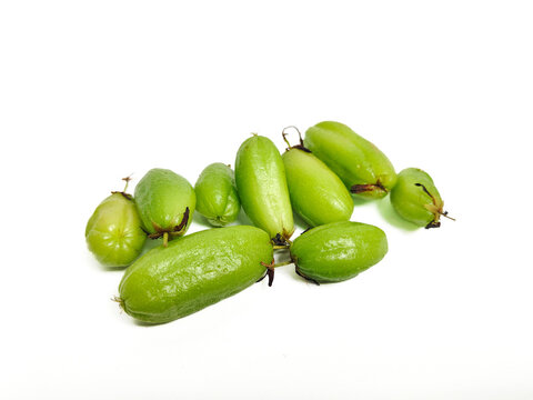 A bunch of young Averrhoa bilimbi fruits isolated on white background. Fresh green tropical bilimbi fruits known for its tangy flavor, used in cooking and traditional cuisine or marinades and sauces