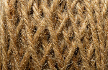 Fototapeta premium Macro shot of natural brown jute rope coil texture background,Extreme close-up shot showing the detailed texture and intricate weaving of a natural brown jute rope spool, perfect for rustic background