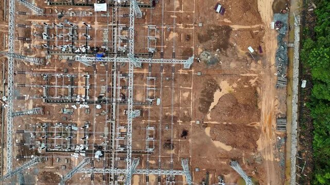 A view from above the substation currently under construction, showing the power lines, poles, and earthwork.