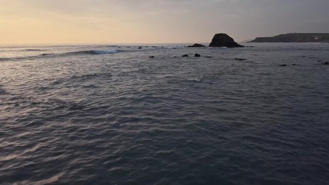 Low flying drone over Widemouth Bay sea
