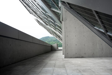 Naklejka premium Modern architectural concrete corridor with glass roof structure and geometric design elements