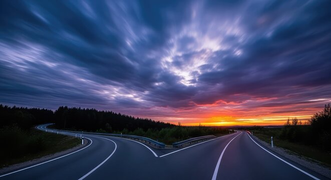 Two divergent paved roads separate under a dramatic cloudy sky at dusk, illustrating the metaphorical choice between different life options, crossroads, destiny, travel