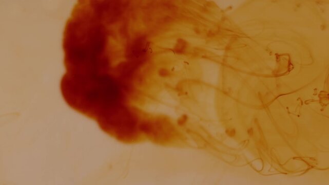 Macro shot of iodine blending into water creating intricate organic shapes