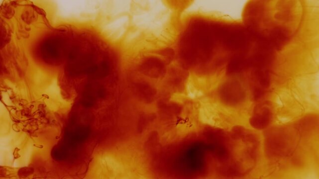 Iodine dissolving in water creating abstract flowing patterns and organic motion