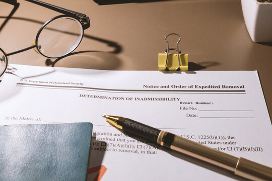 Department of homeland security determination of inadmissibility and expedited removal notice on desk
